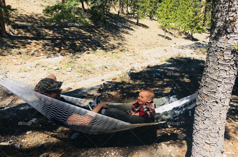 Happiness is hanging in this white hammock with my dad wearing a red flannel shirt and seeing him smile back at me! Camping!