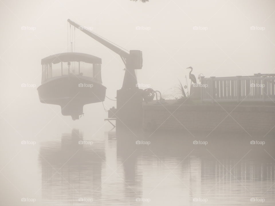 Boat on lake on a foggy day