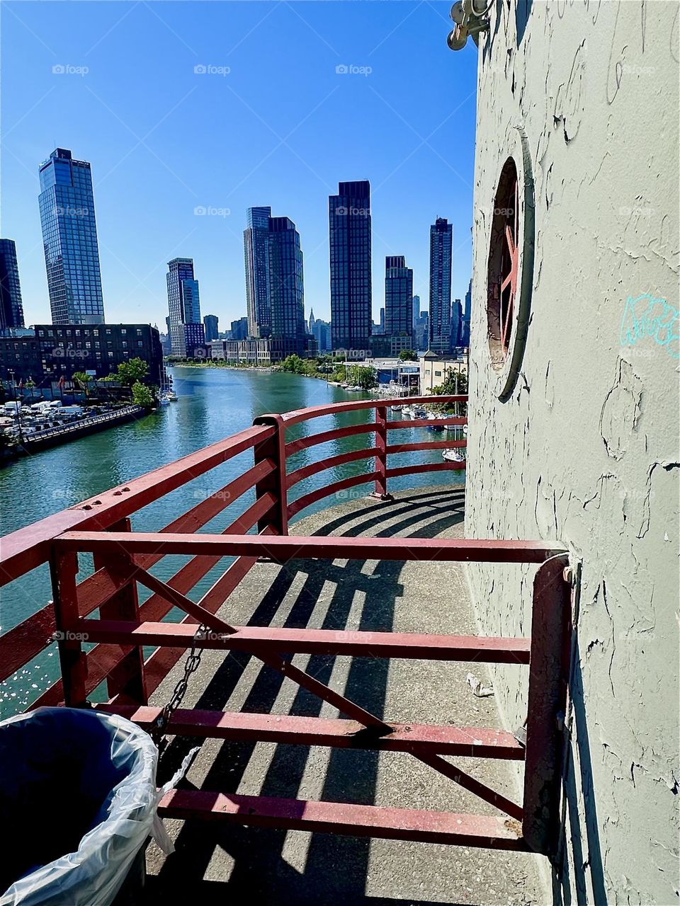 This is the central outpost of the “Pulaski Bridge” at “Newtown Creek” that connects “Greenpoint”, Brooklyn to LIC, Queens. Across the “East River” we see “Greenpoint” on the left, LIC and “Manhattan” on the right. 2024. Hypnotic Productions