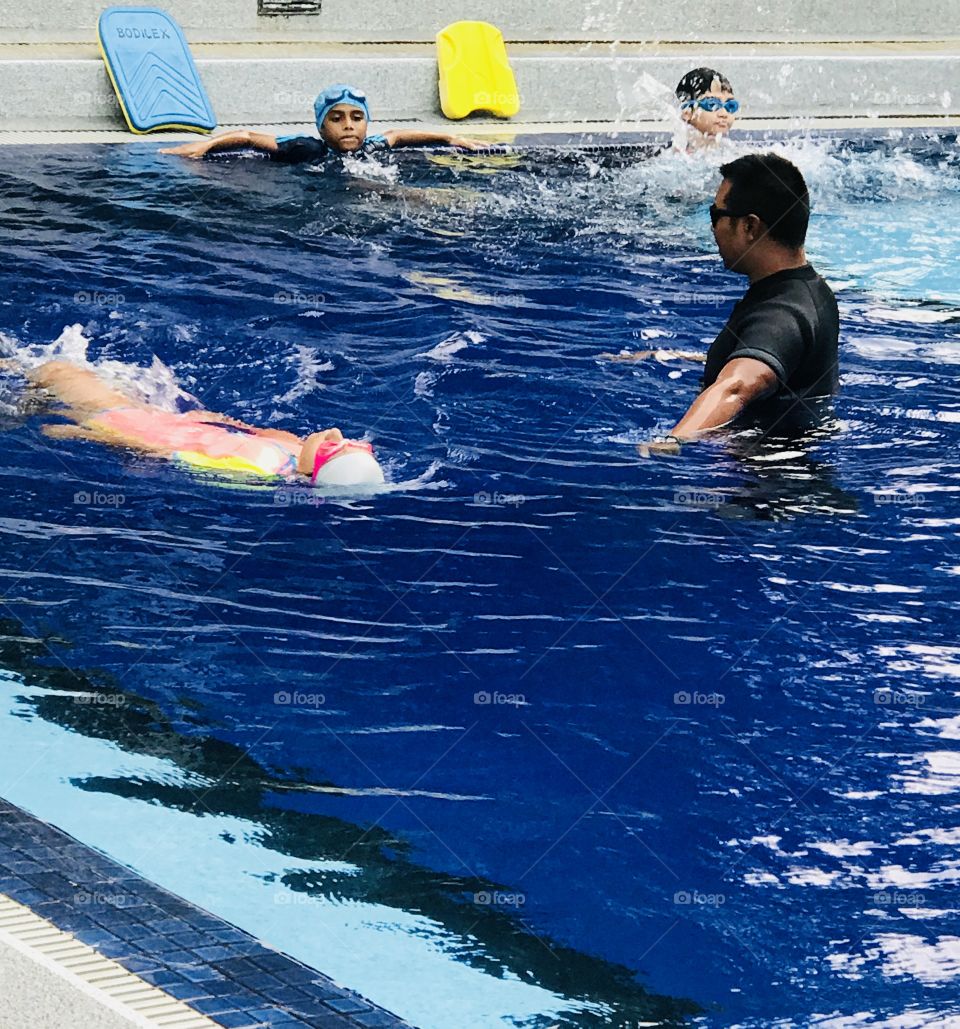 Swim coach teaches his students