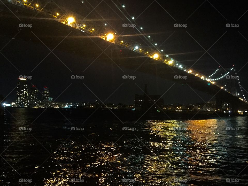 East River. . Beautiful Fall night, gazing out to the river at the historical Williamsburg Bridge, gleaming it lights! 