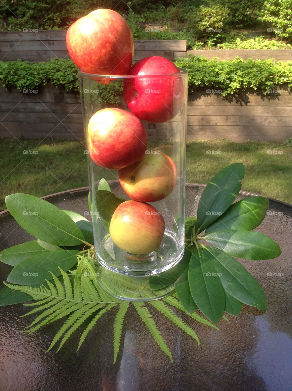 Apples in a vase as a centerpiece for a table.