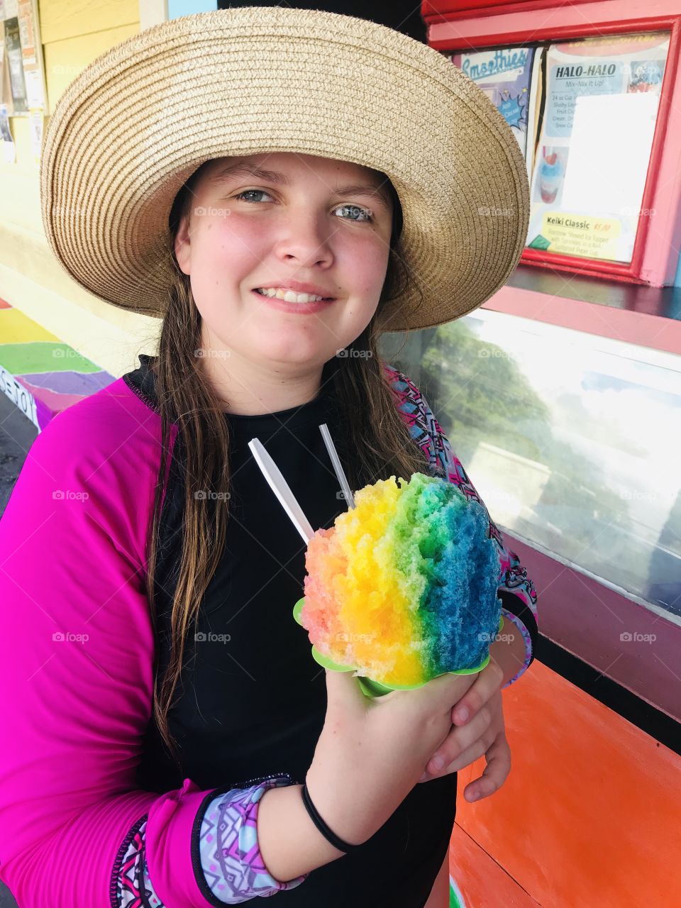 Darling girl in Hawaii with her traditional icy cold Hawaiian Ice drink complete with multi colored flavors!  