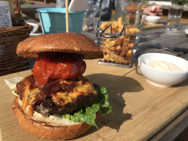 Deluxe hamburger with a basket of chips