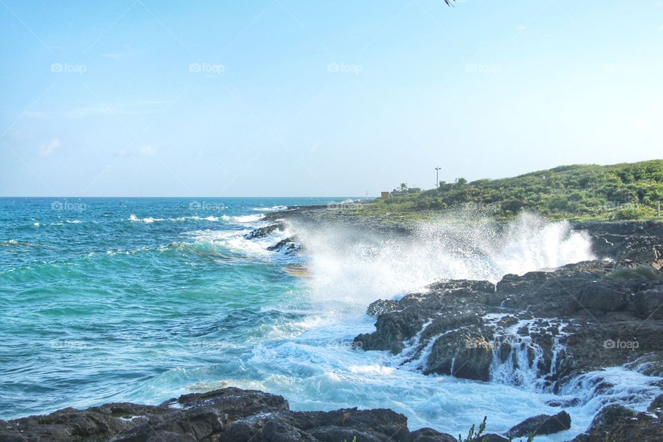 Water coming out of pressure between rocks in surf break