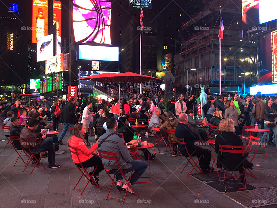 Sitting on chairs at Times Square 