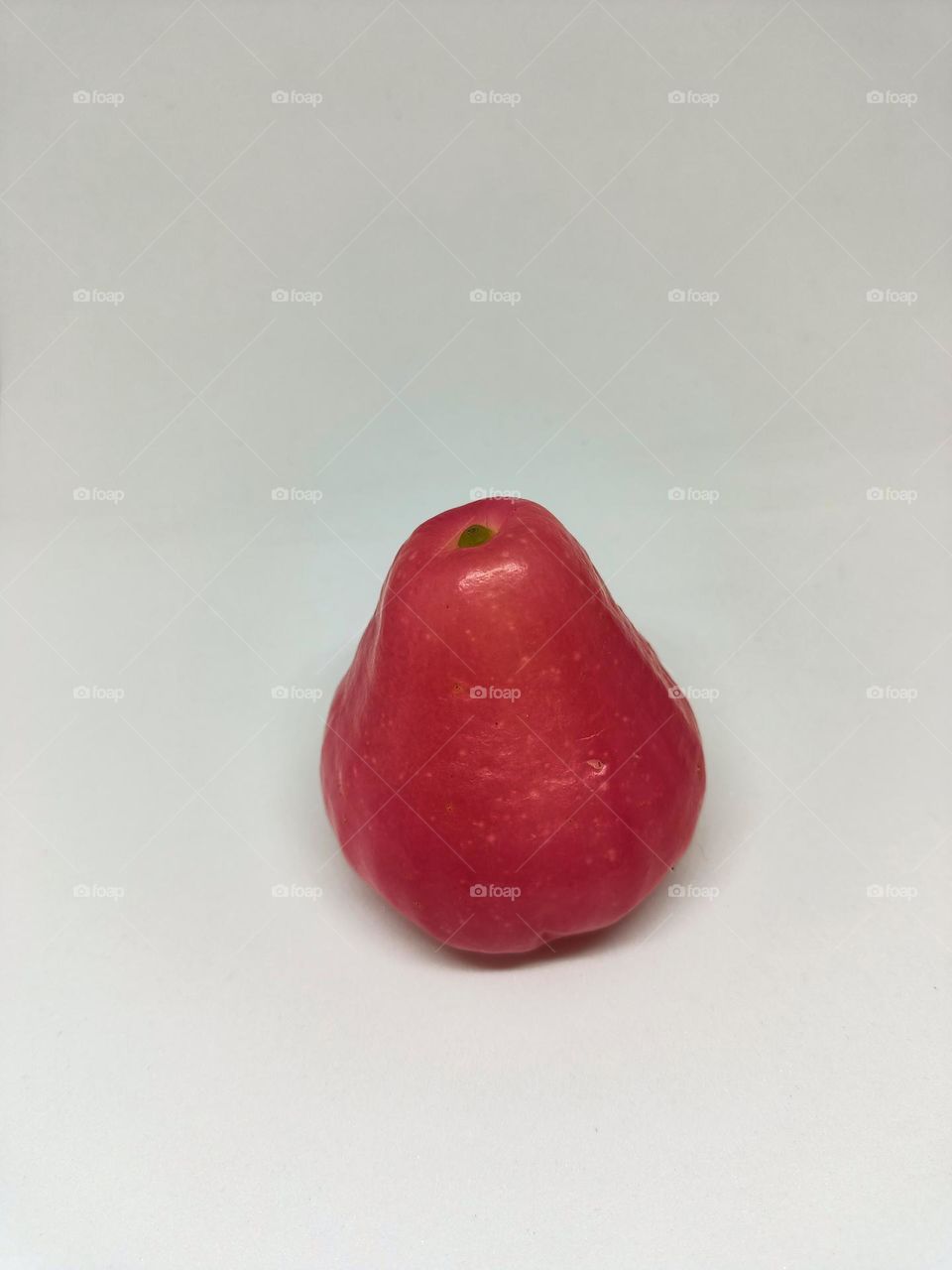 Close up of wax apple isolated on white background. Selective focus, underexposed, blurry, low light, too soft