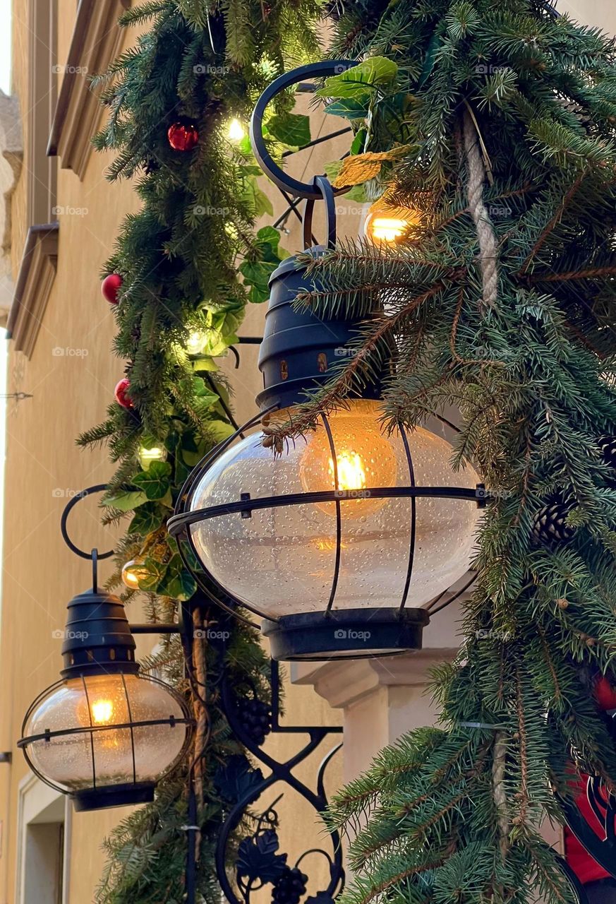 Street lamp with Christmas decoration above the door