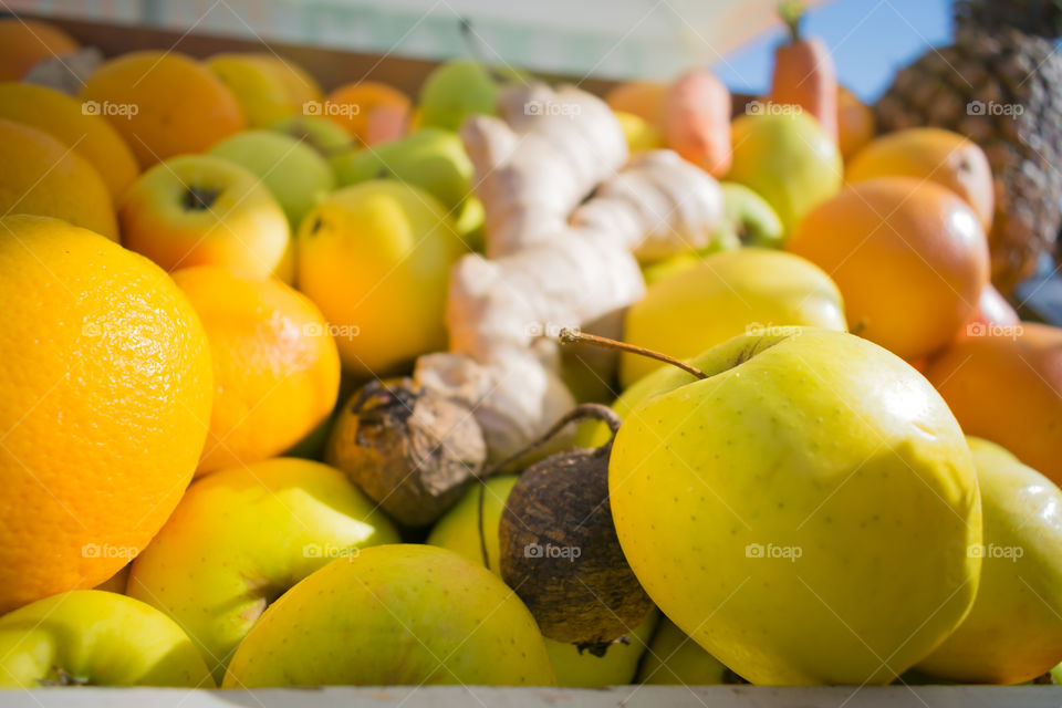 Close-up view of Fresh apples and oranges and ginger