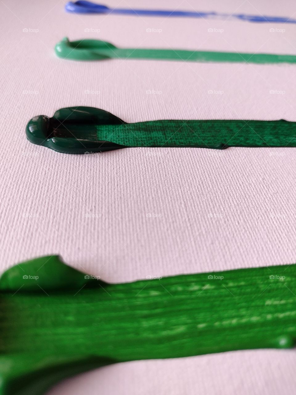 Unfiltered, beautiful, lovely close-up of green paint on a canvas