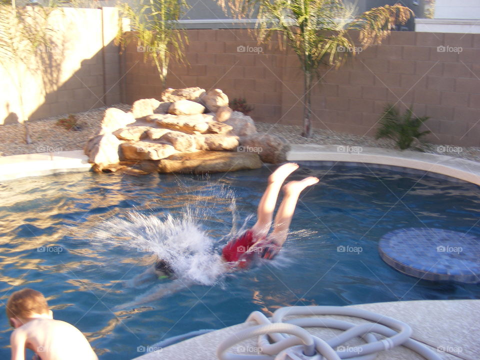 Boy diving into pool