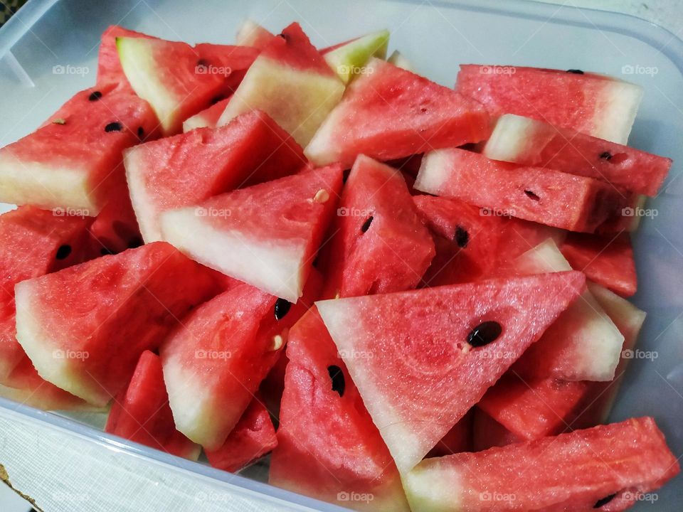Pile of watermelon pieces in a triangular shape ready to eat