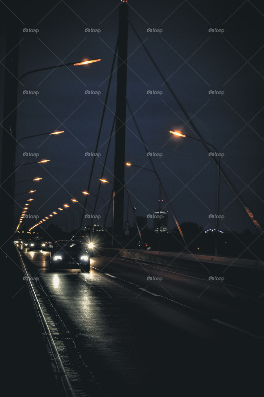 Bridge at night, with cars.
