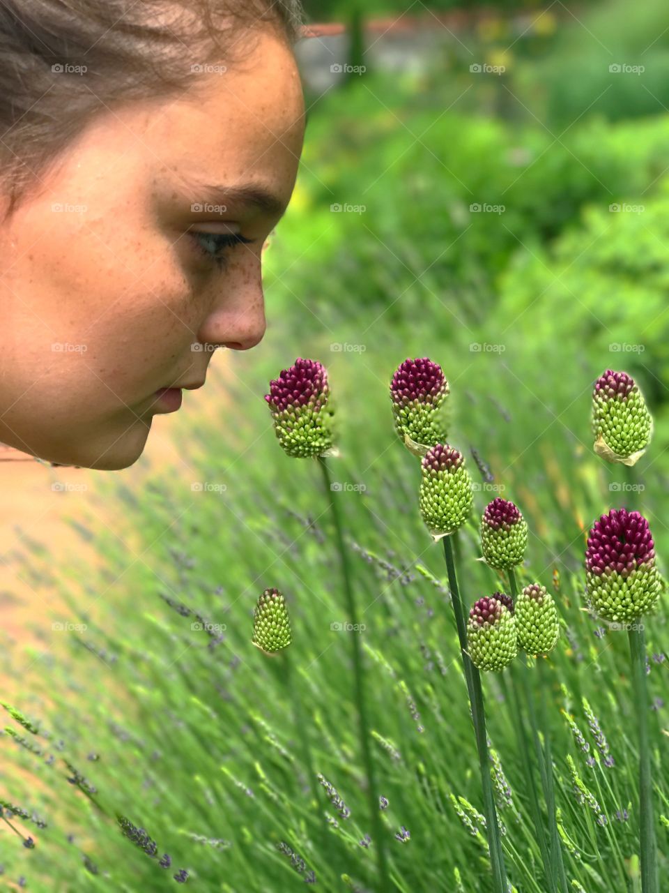 Girl smelling flowers in garden