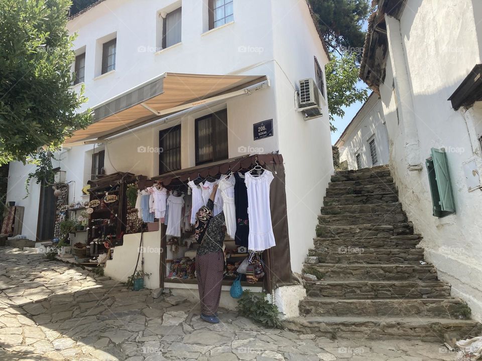 Greek village in Turkey. Blue sky and tall palm trees. Sunsets and sunny days. Summertime in Kusadasi. Vacation travel in Turkey . Summer view. Sunny day during vacation 