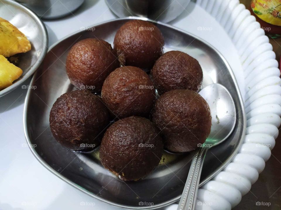 Gulab jamun (also spelled gulaab jamun) is a milk-solid-based sweet, originating in Medieval Iran.and a type of mithai, popular in India, Nepal, Pakistan, the Maldives etc.