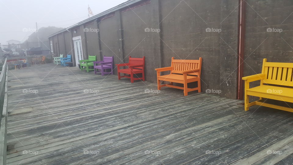 rainbow chairs in the fog