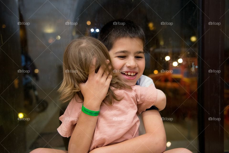 boy haugging his little sister