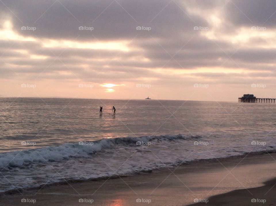 Stand up paddle boarding at sunset