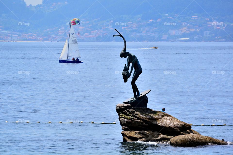 Statue on a rock at Silgar beach, Sanxenxo, Spain.