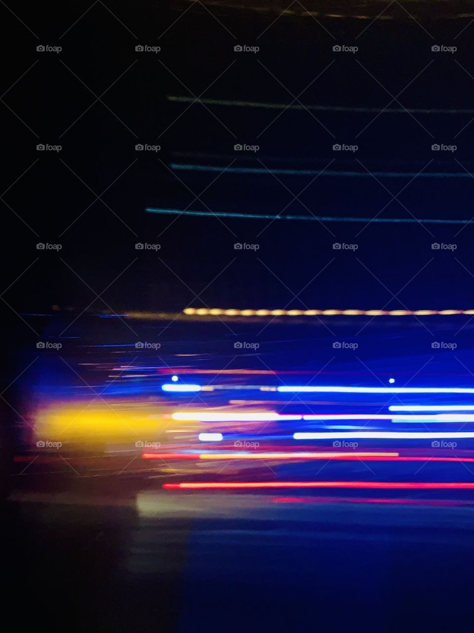 Abstract of colorful blurred lights in motion against black background