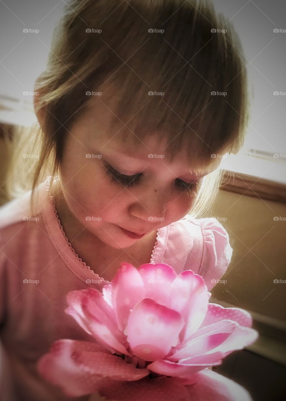 portrait of a precious little girl in pink with her pink flower
