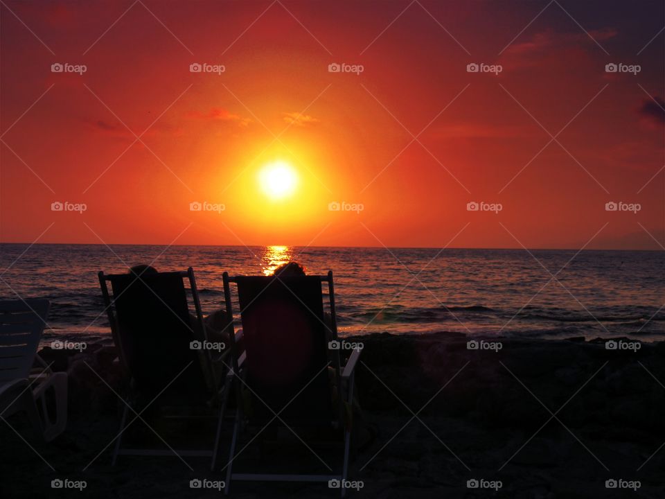 Sunset over Palinuro ( Italy ) with deckchair silhouette.