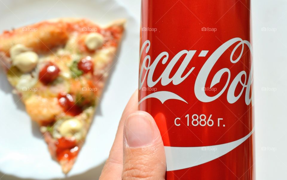 coca cola in the female hand and pizza tasty food