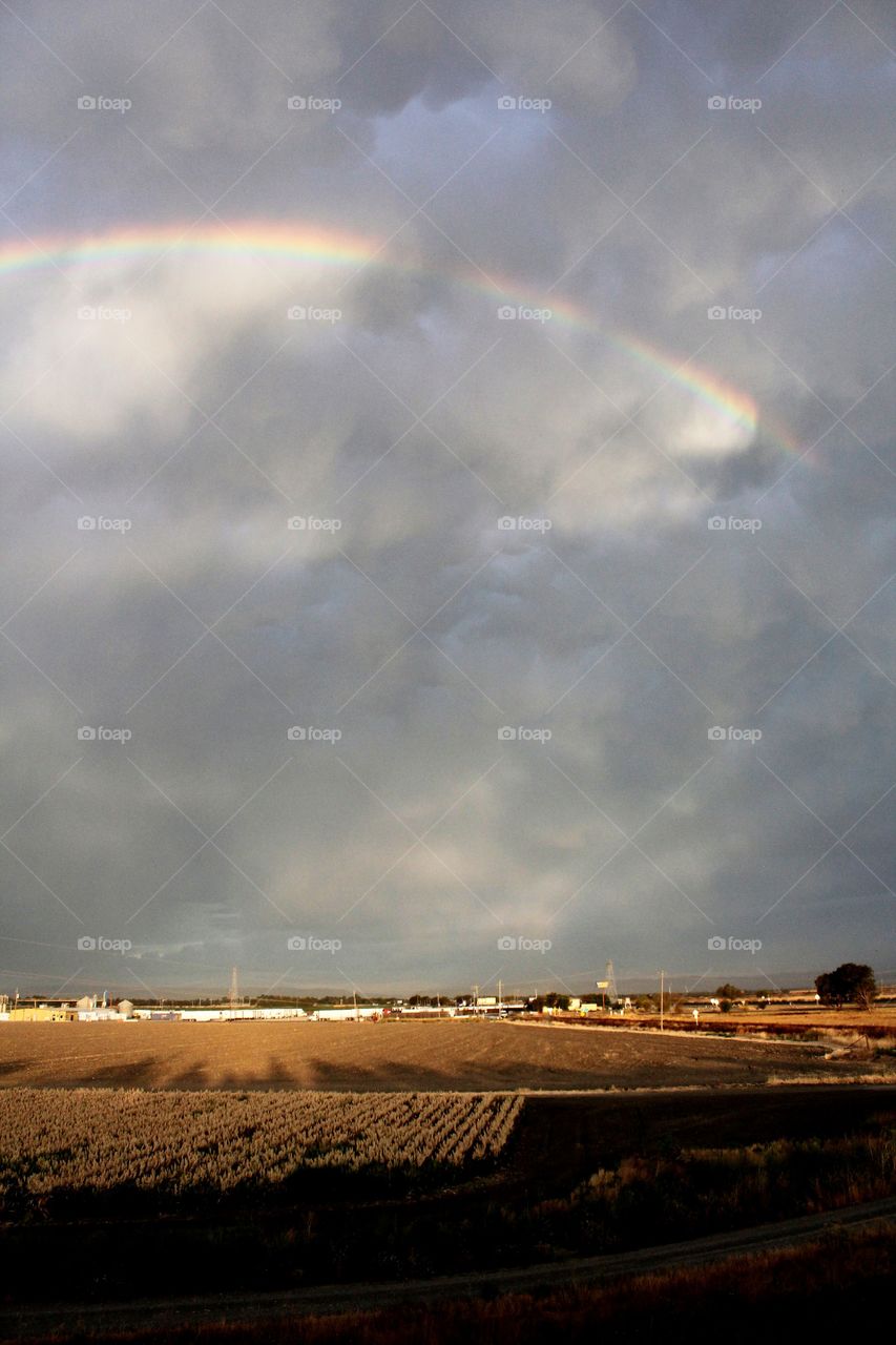 rainbow thunder clouds in a landscape view.