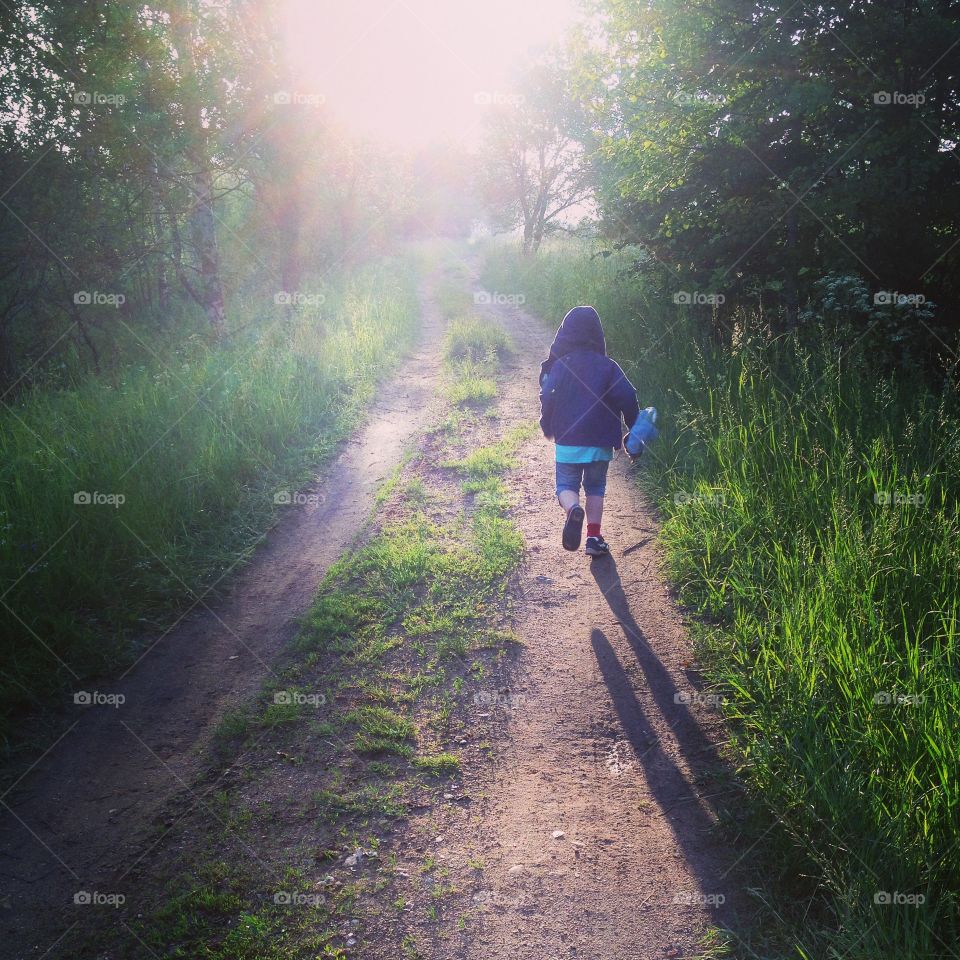 Little boy. the little boy runs along a forest road