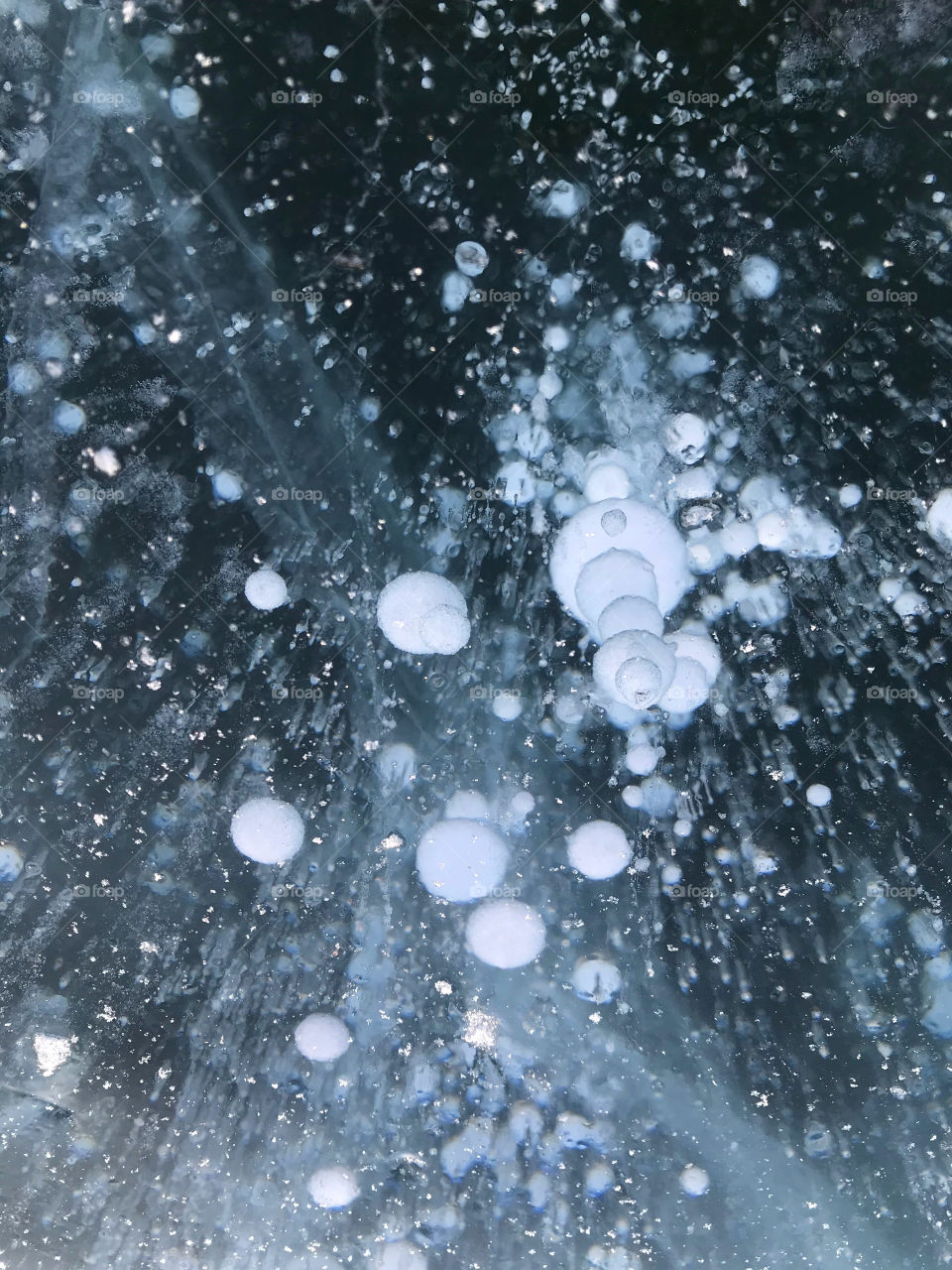 Bubble beneath ice lake surface in Russia