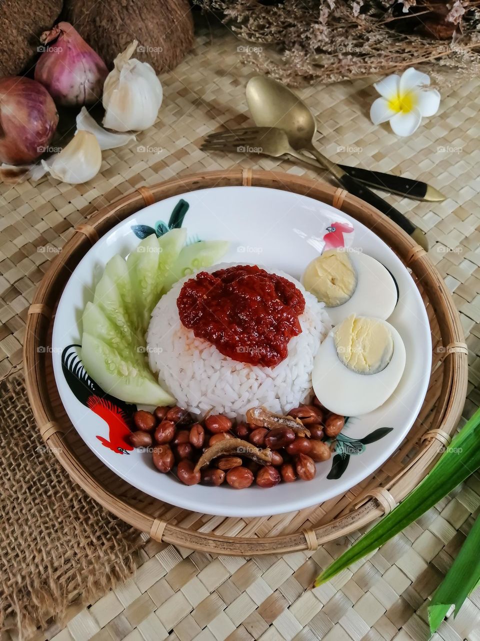 Nasi lemak is a Malay fragrant rice dish cooked in coconut milk and pandan leaf. It is commonly found in Malaysia.