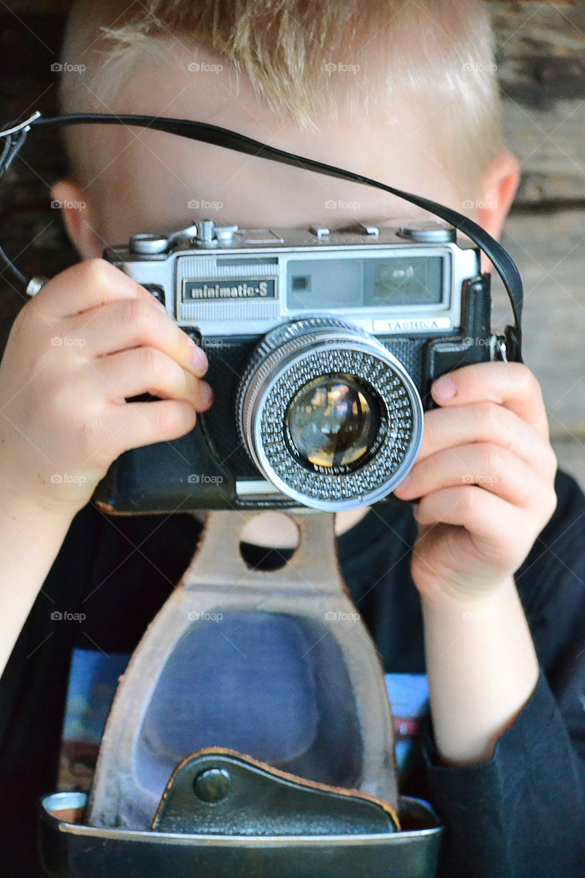 Boy with a vintage camera