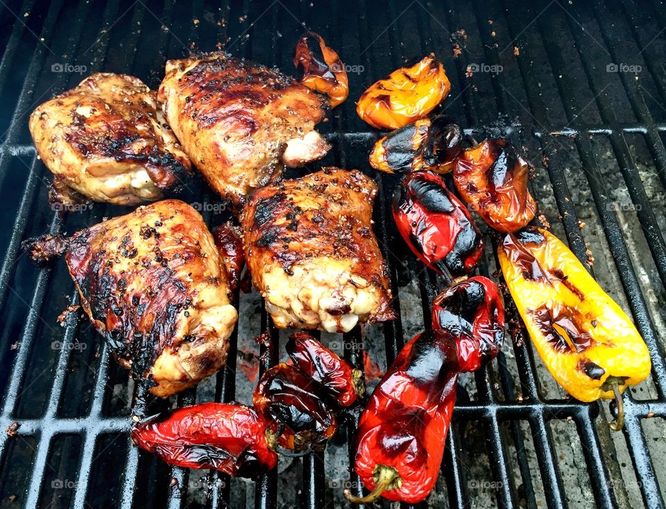Chicken and Peppers on the Grill. Chicken and color peppers cooking on the grill.  