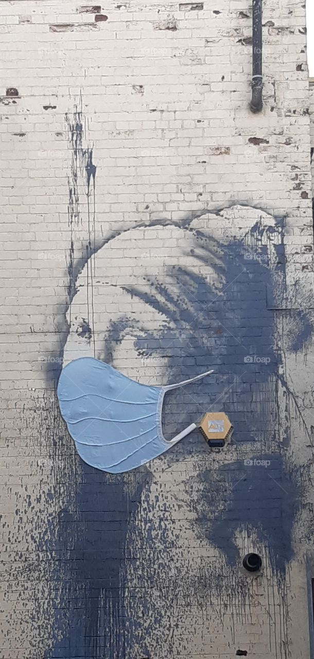 Girl with a pearl earring by Banksy wearing a mask for covid19. Originally she was not wearing a mask and still unsure at the moment whether banksy put the mask on her or it could of been put on by another street artist