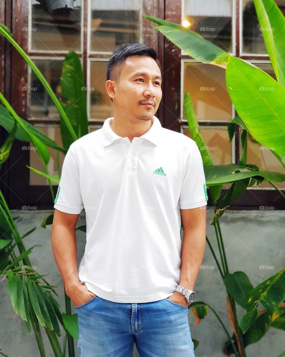 Man standing hands in pockets