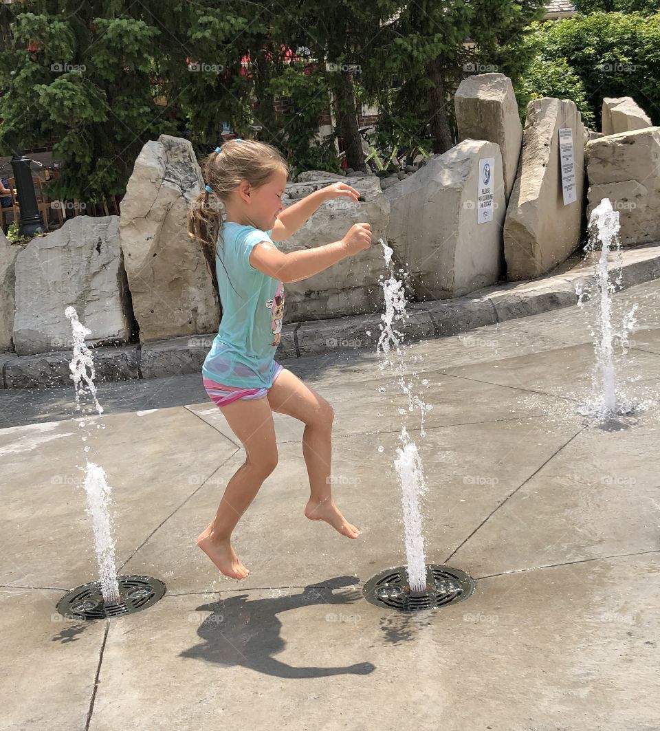 Jumping Through Water At A Water Park