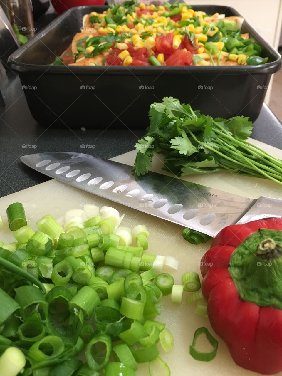 Cutting board with knife and chopped vegetables 