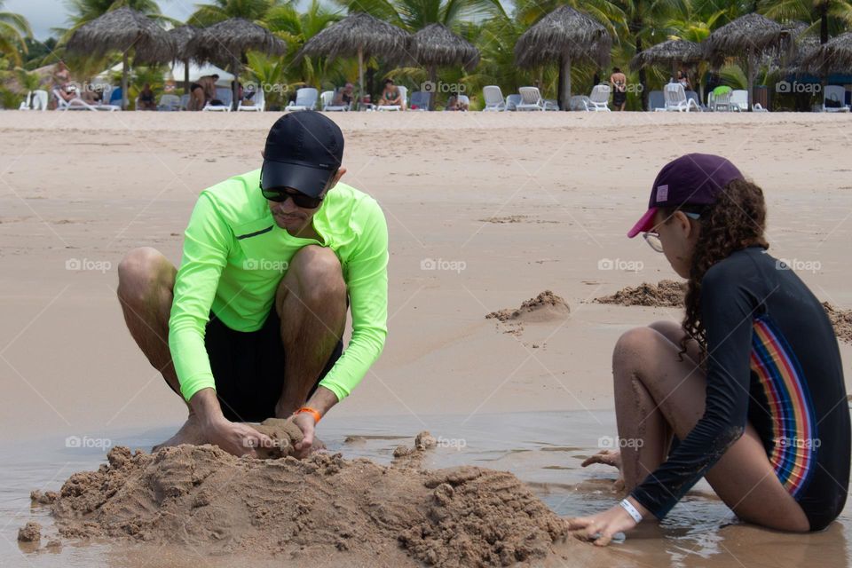 Father and daughter on the beach in summer