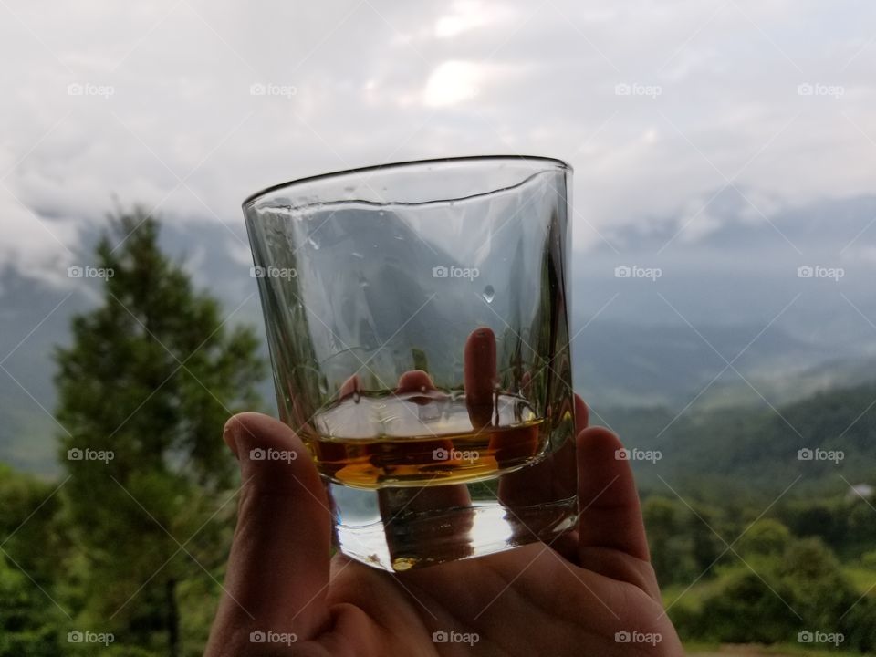 whiskey glass with mountains in background