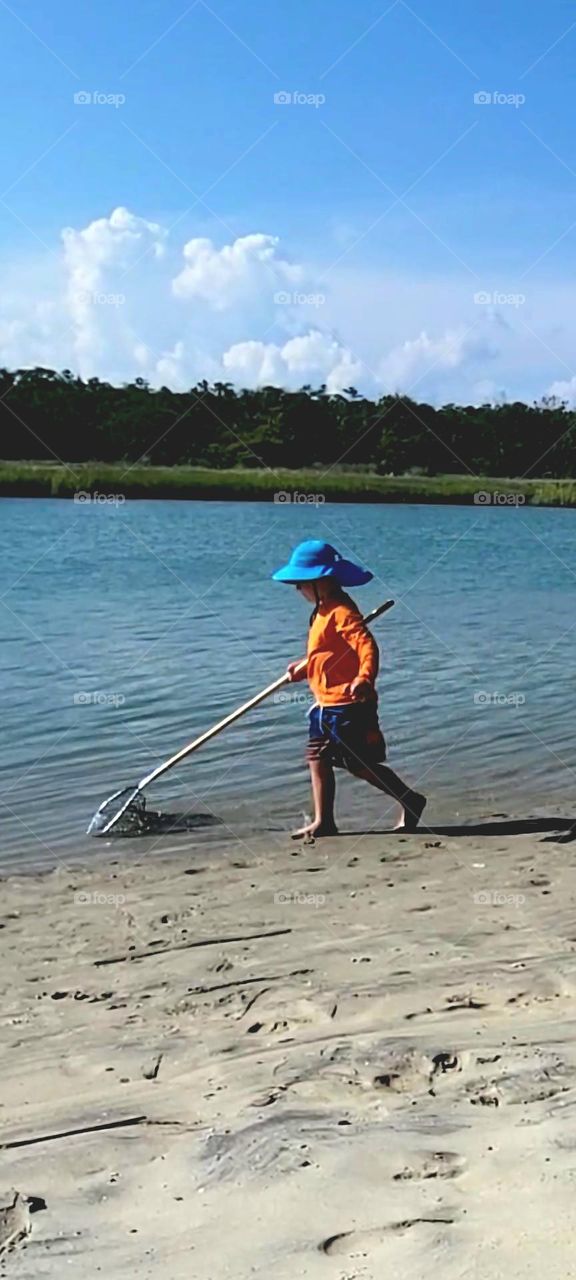 fun in the sun young boy with fishing net