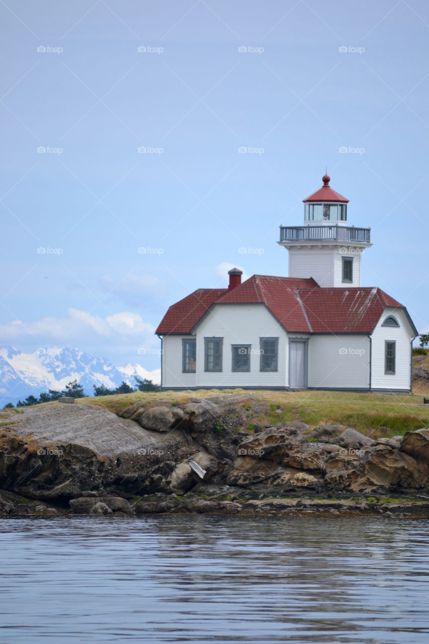 This photo of a lighthouse was taken out on the ocean around the San Juan Islands Washington. 