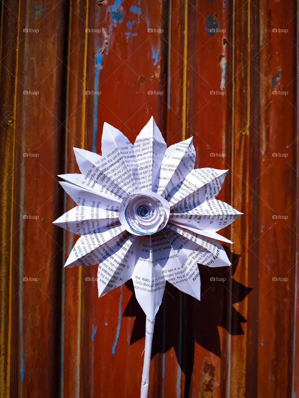 Sunflower flower made of white paper against the backdrop of the old door.