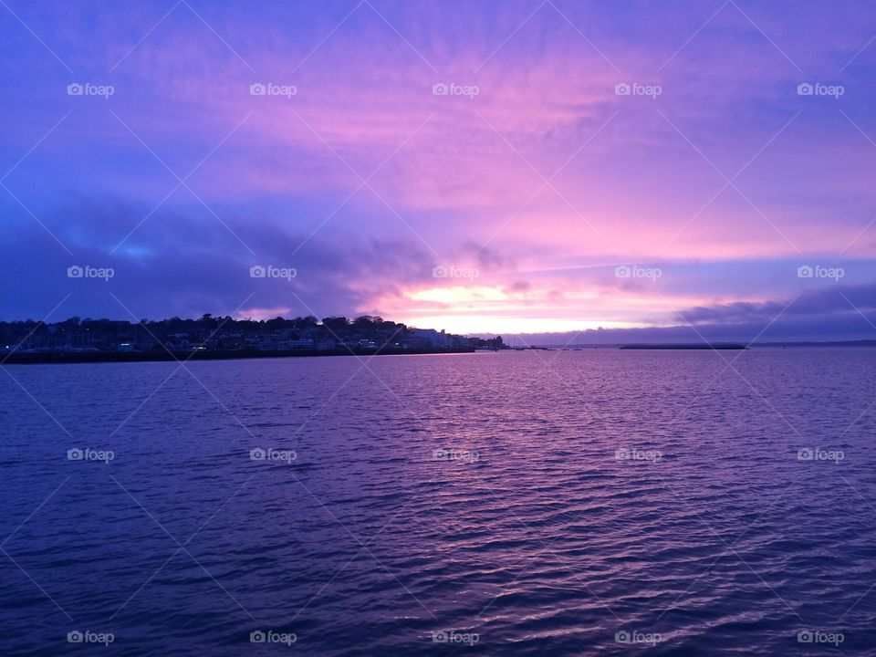 Purple sunset on calm sea 