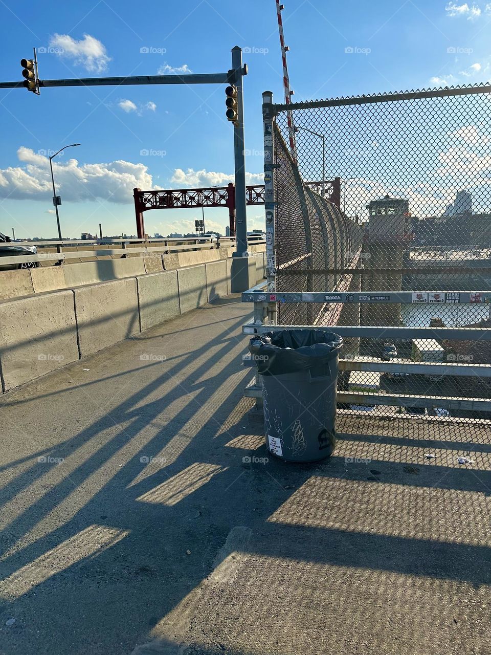 The “Pulaski Bridge” at “Newtown Creek” in LIC, Queens has constructivist architectural elements that cast ever changing interesting shadow patterns onto the asphalt of the pedestrian lane. 2023. Hypnotic Productions