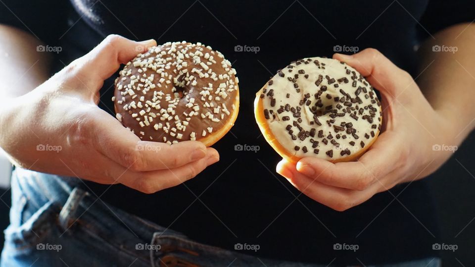 Close-up of person's hand holding donut