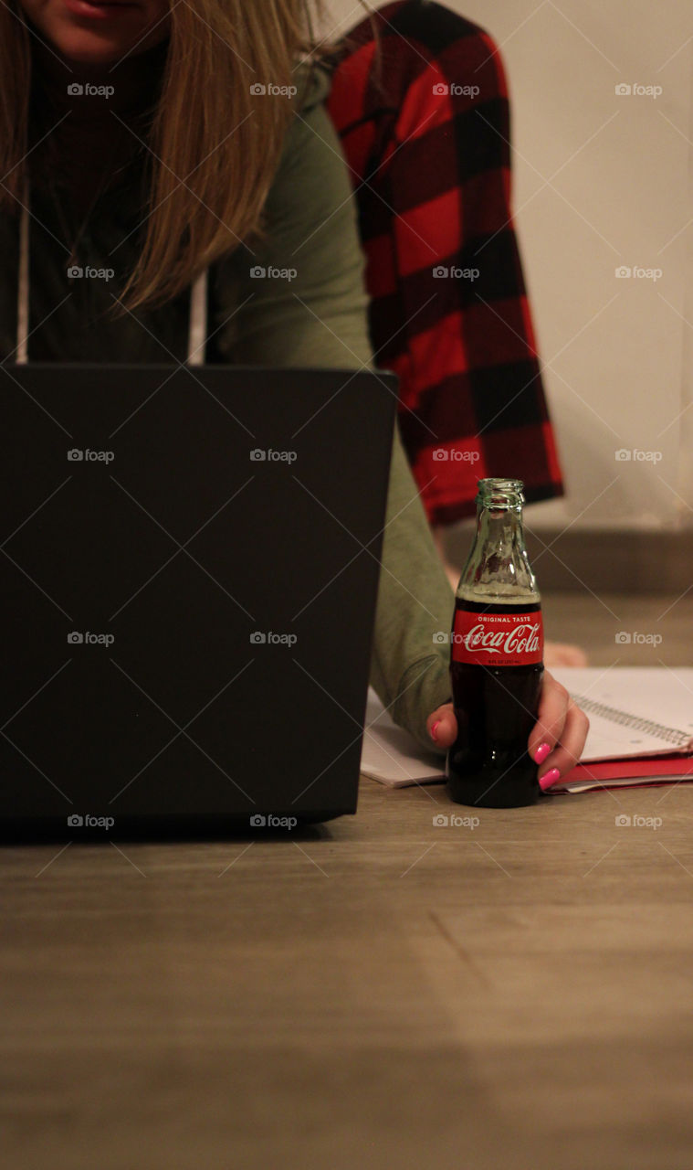 Woman enjoying a coke while studying