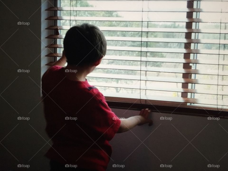 Boy looking out window 