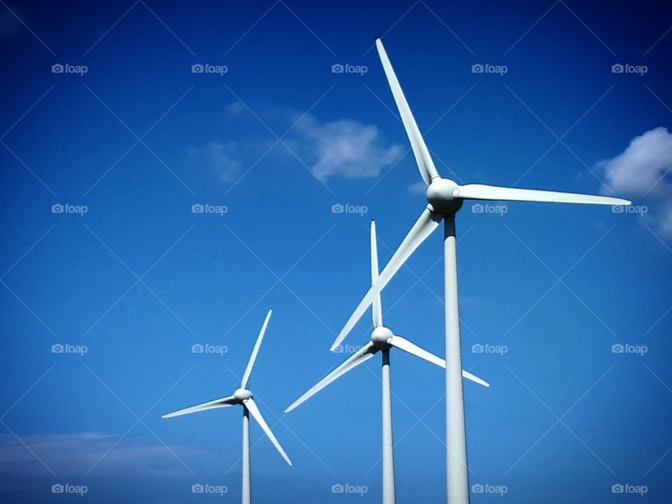 Wind turbines with blue sky in background