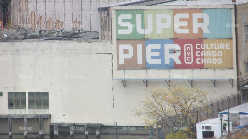 Old Colorful “Super Pier” Metal Sign on an Old City Building Version 2